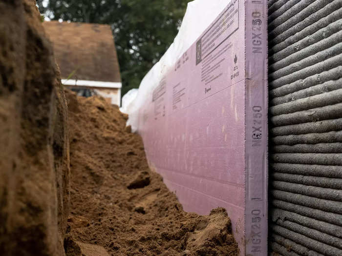 Insulation is placed between the ground and the cement.