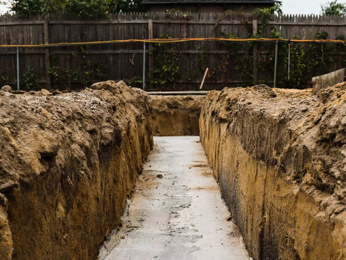 First, it started with the footing — which began about three feet underground. The trench is backfilled with cement, Henry explained.