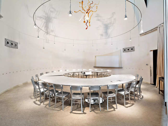 The former altar space has been converted into a board room with a curved, horseshoe-shaped marble table that can seat 30 people.