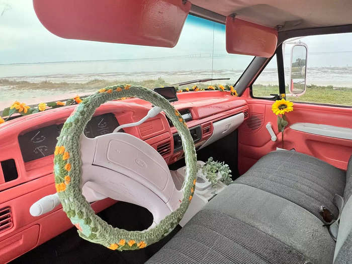 The van, which was originally made in 1996, now features a pink dashboard and white steering wheel with a floral crochet cover.