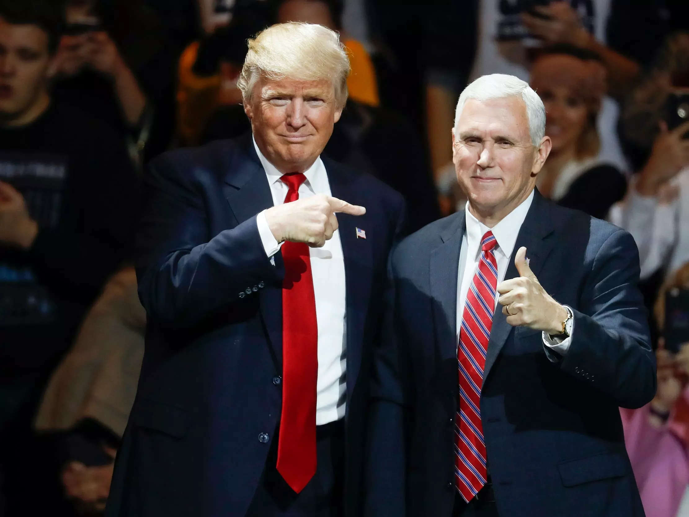 Former President elect Donald Trump, left, and former Vice President Mike Pence acknowledge the crowd during the first stop of his post-election tour, in Cincinnati on December 1, 2016.