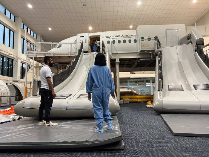 One trainer stood at the end of the slide and there was a pad on the floor to ensure no one got hurt. There are also side rails for safety — but they are absent from real emergency slides.