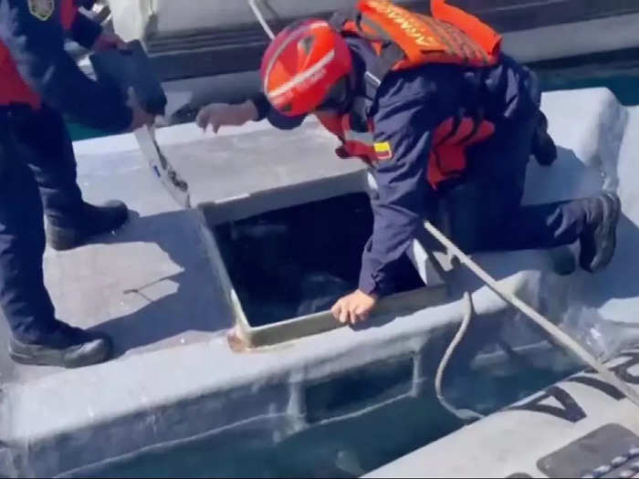 In the footage posted to Twitter, officers are seen unloading the thousands pounds of cocaine from the vessel.