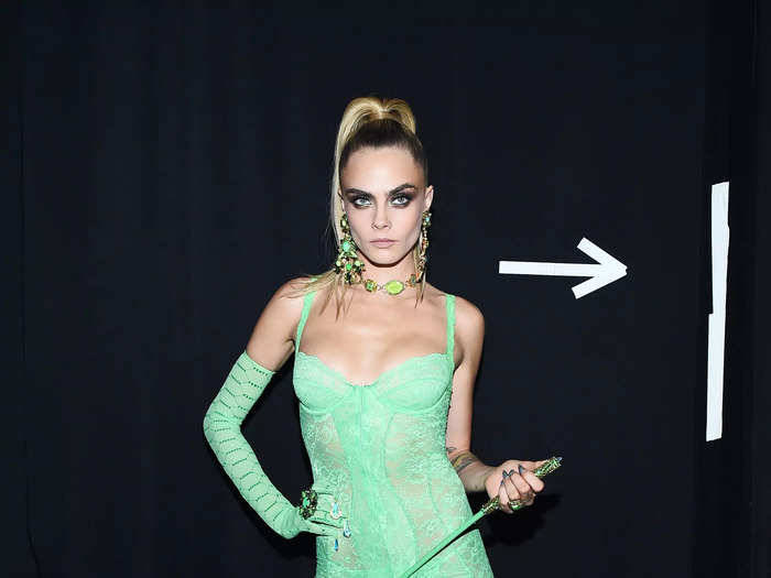 Delevingne was dressed appropriately for the Savage X Fenty fashion show in September 2019, wearing a mint-green lingerie-inspired dress, matching thigh-highs, and opera gloves.