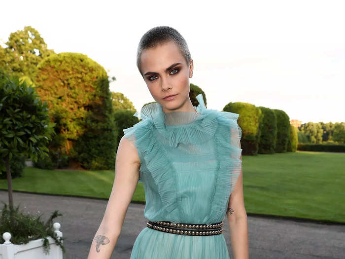 In June 2017, Delevingne wore a teal dress with a sheer tulle overlay and a matching teal bodysuit.