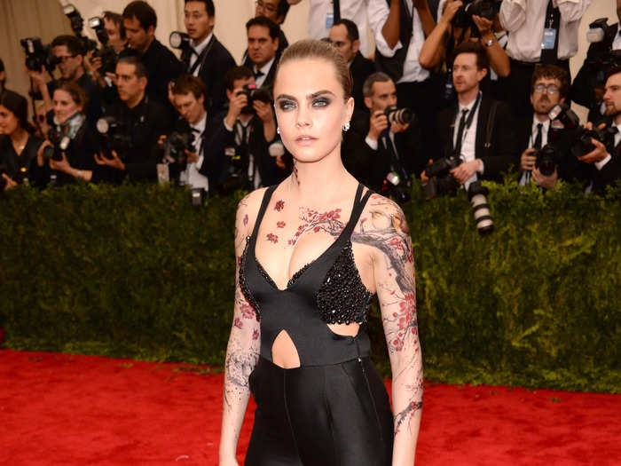 At the 2015 Met Gala, Delevingne covered herself in cherry-blossom fake tattoos and wore a skin-tight black jumpsuit with a keyhole cutout.