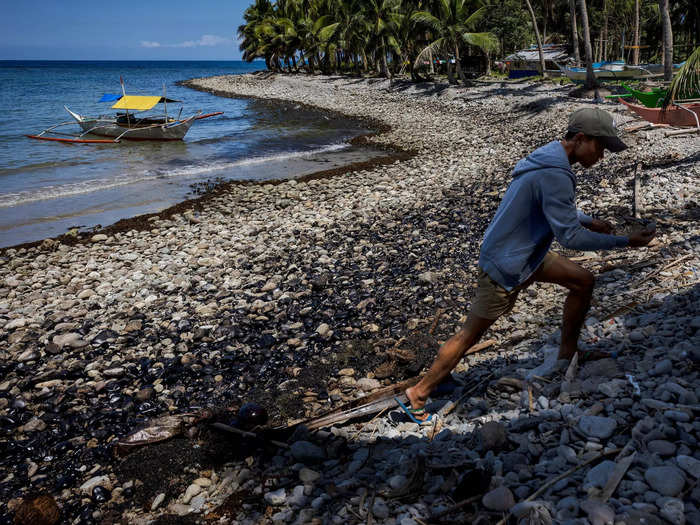 The shoreline has been coated in thick sludge. According to locals, even when the shoreline is cleaned, it becomes dirty again when the tide rises and brings in new oil.