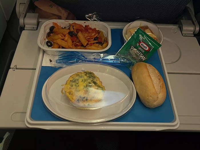 About an hour after takeoff, the flight attendants served dinner. My meal came with pasta, an egg and spinach muffin-looking dish, bread, and a caramel dessert.