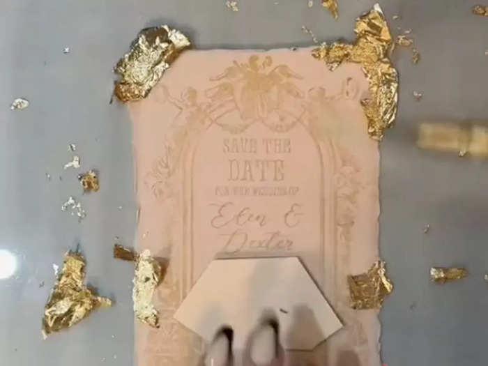 She glued gold foil to the corners and brushed away the excess.