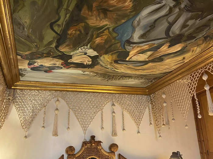 Above the bed, a painting of the couple and their daughter was repurposed as a canopy.