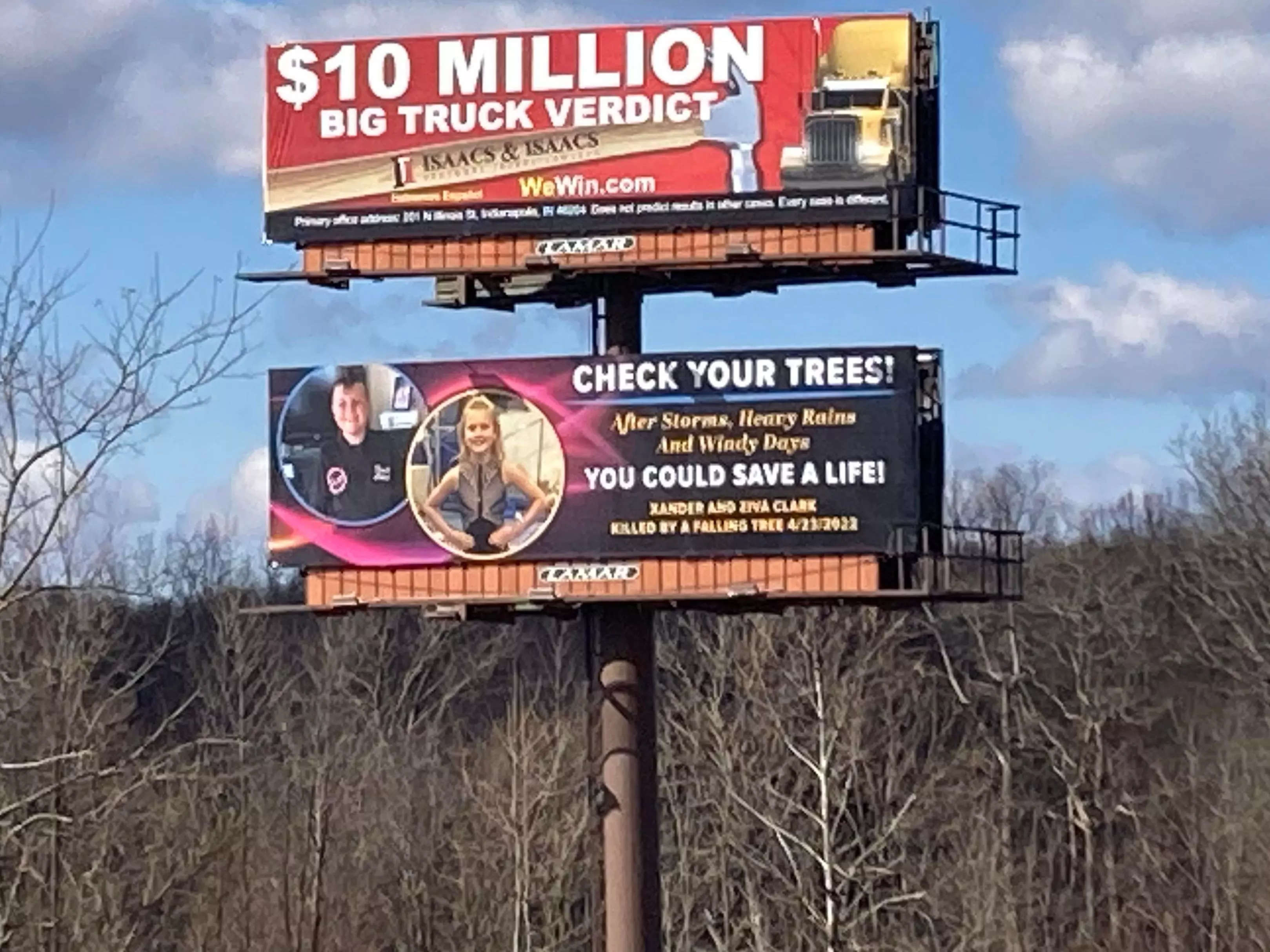 A billboard placed by Crystal and Brian Clark warns onlookers to check their trees.