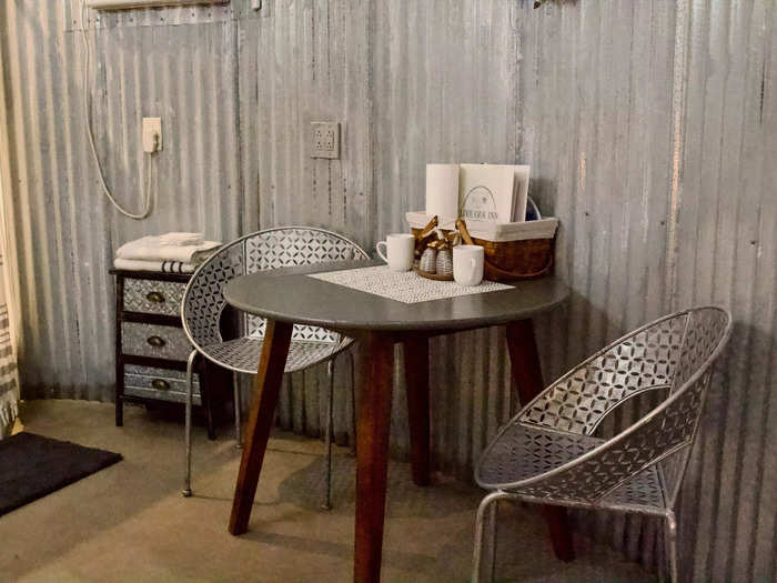 Against another wall of the grain bin, there was a small dining table with two metal chairs.