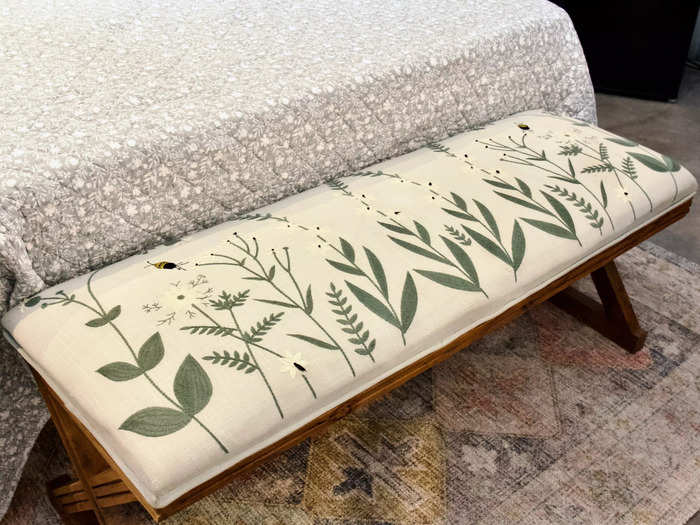 I paused to admire an upholstered bench with embroidered images of bees and plants.