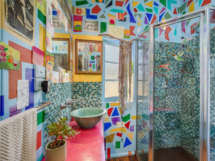 Even the bathroom walls are covered in a bright DIY mosaic.