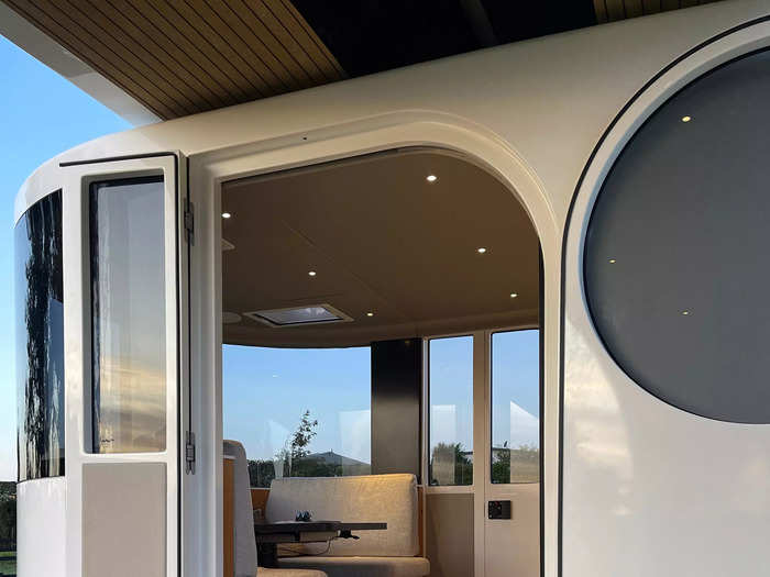 The main cabin includes a spacious dining lounge that is surrounded by wraparound windows.