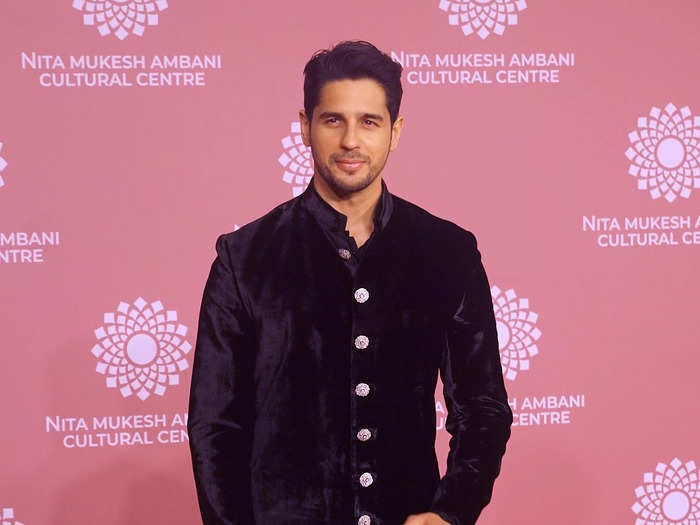 Sidharth Malhotra wore a black sherwani with silver buttons.