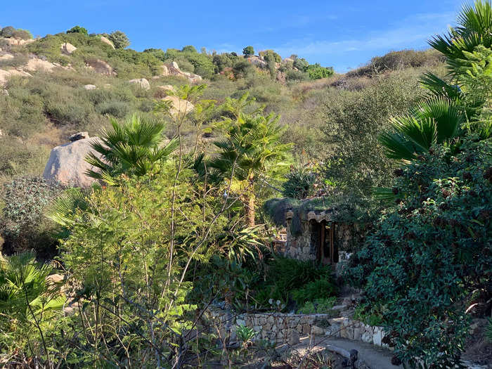 When I first glimpsed the hobbit home, I thought it looked like a fantasy built out of natural rocks and wood, surrounded by lush greenery.