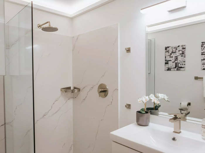 The bathroom, located at the foot of the bed when it is folded down, has a classic sink and a quartz-lined shower.