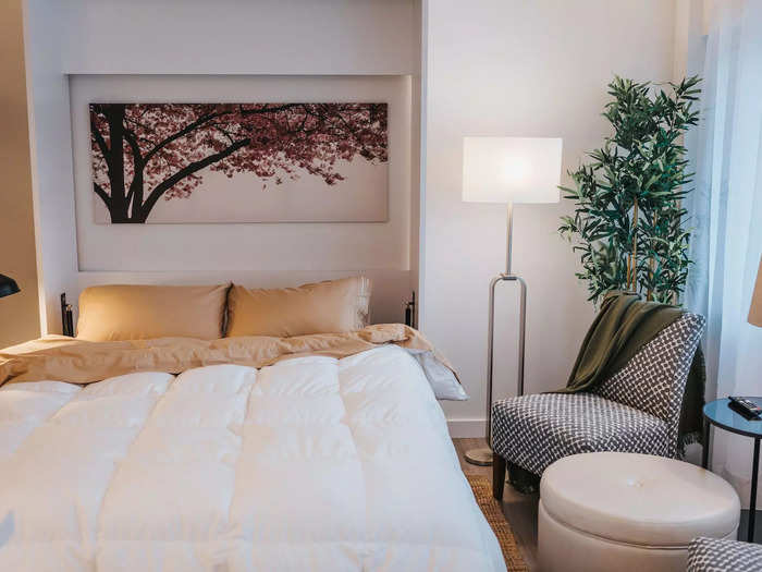 The queen-sized Murphy bed pulls down to reveal artwork with cherry blossoms.