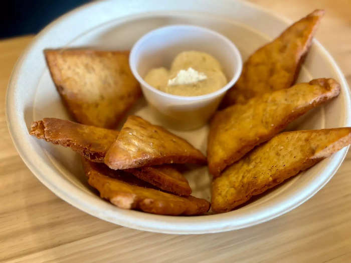 Cava serves pita chips with dips and toppings. Choices include roasted eggplant, crazy feta, hummus, harissa, tzatziki, and red pepper hummus. The pita chips, cooked in-house daily in small batches, are crunchy but not as oily as tortilla chips.