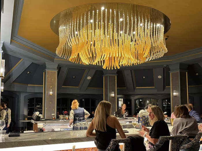 A large golden chandelier, representing Belle