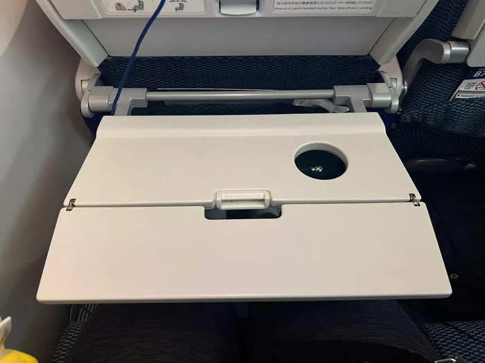 …and a foldable tray table. I liked the hollow cup holder because it held my drink in place during turbulence.