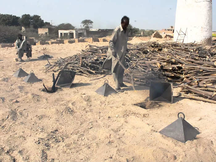 The kilns are covered with sand and gaps are filled with wood. Kiln workers risk their lives with the threat of cave-ins .