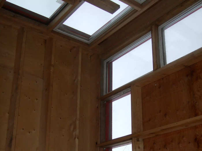 The building itself is quite minimalist with a red exterior made from metal sheets. The interior features cedar wood.