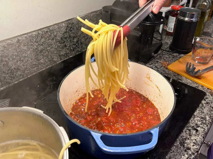 Then, using tongs, I transferred the pasta to the sauce.