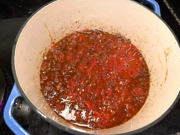 Once the wine had nearly evaporated, I added the tomatoes and sugar.