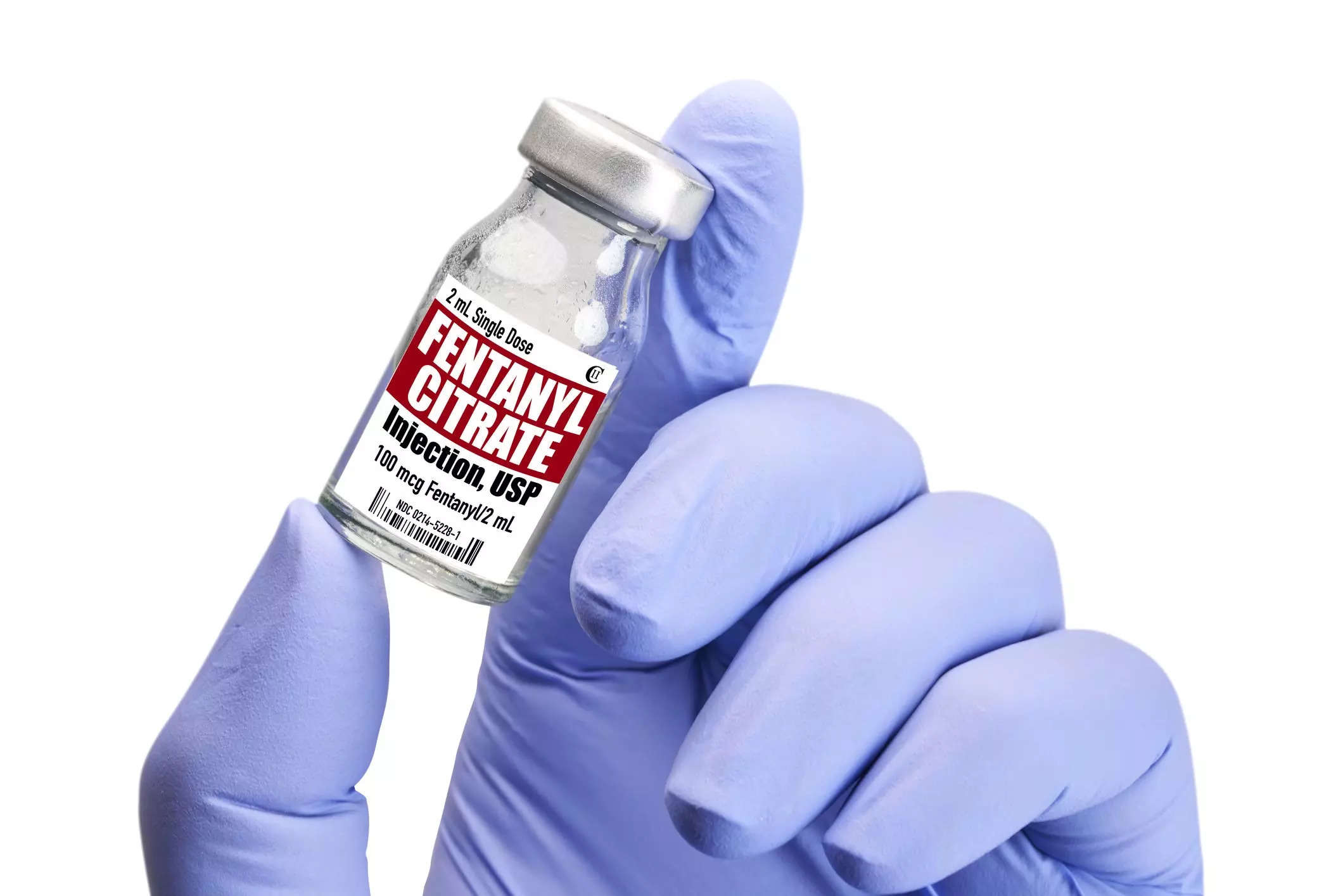 A person holding a small container of fentanyl.