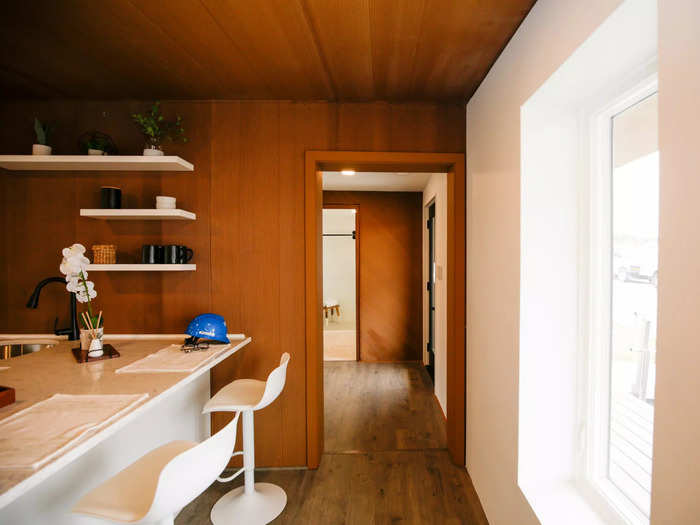 The entrance into the living room and kitchen was across the hall from the bathroom.