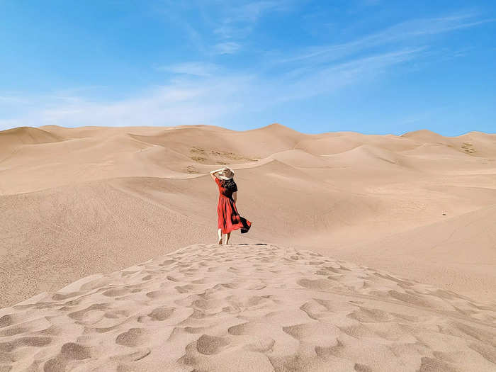 woman walking through a sand dune