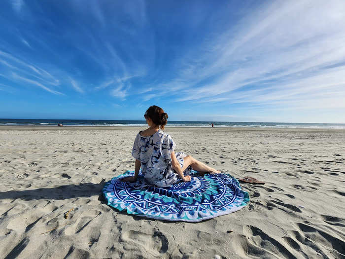 a woman sitting on a beach