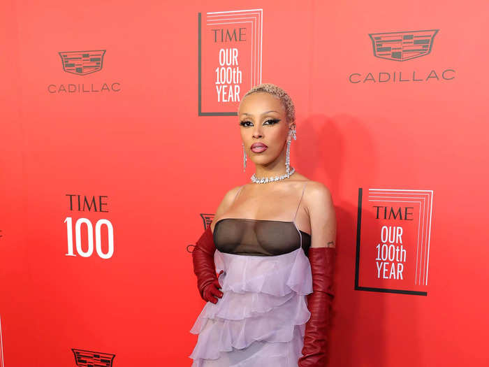 Doja Cat wore a semi-sheer, ruffled gown by Valentino with red gloves.