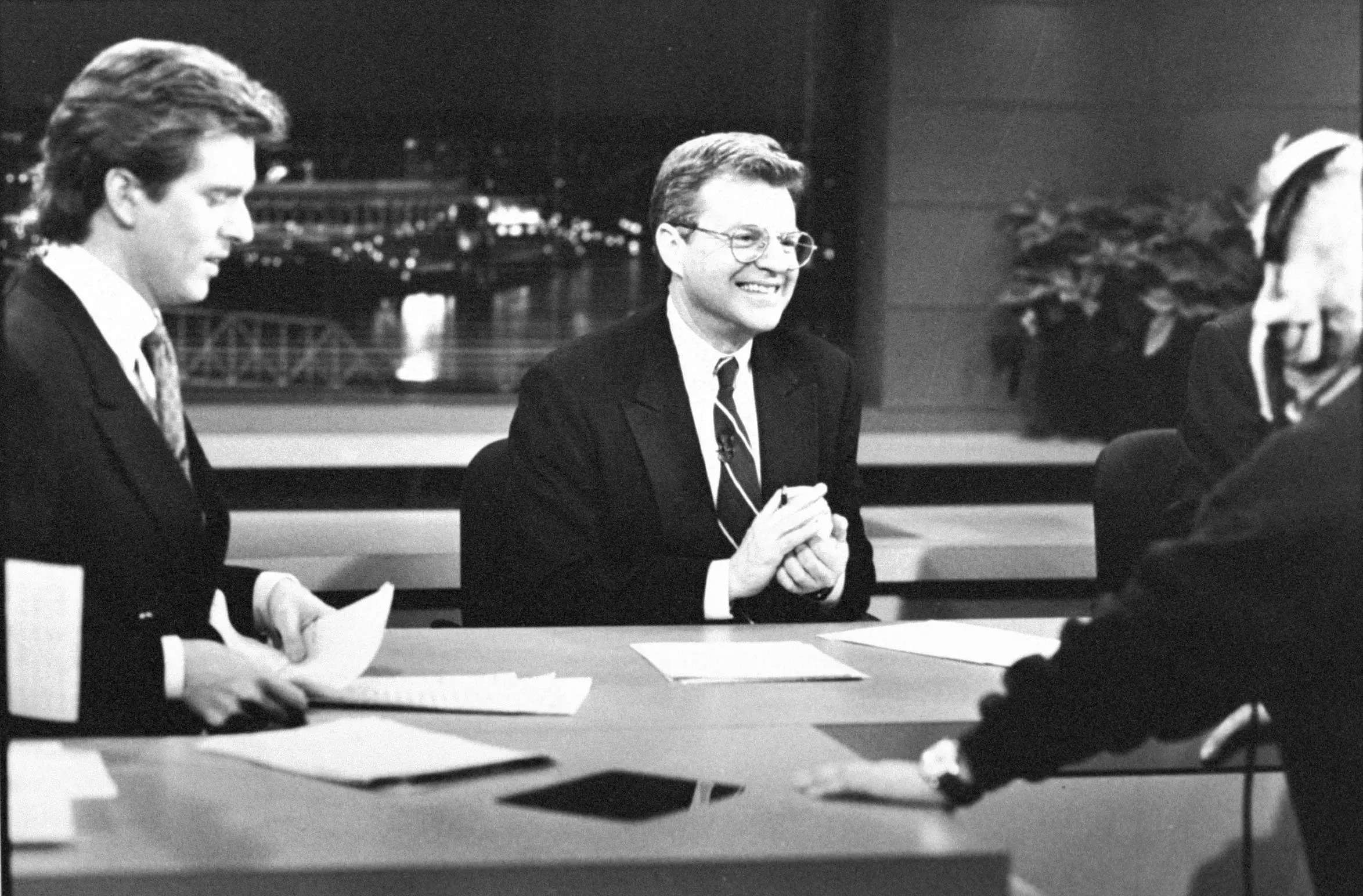 A black and white image of Jerry Springer speaking to Jim Watkins and a technician on a news set at WLWT-TV.