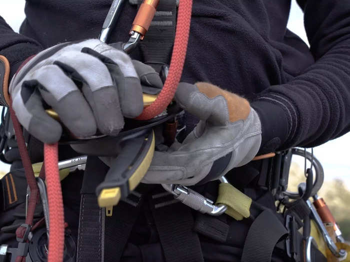 João and his partner use leather gloves, helmets, nonconductive boots, and harnesses to stay safe. "We have to verify once, verify twice, until you feel safe," João said. "If you fall, there are no more chances."