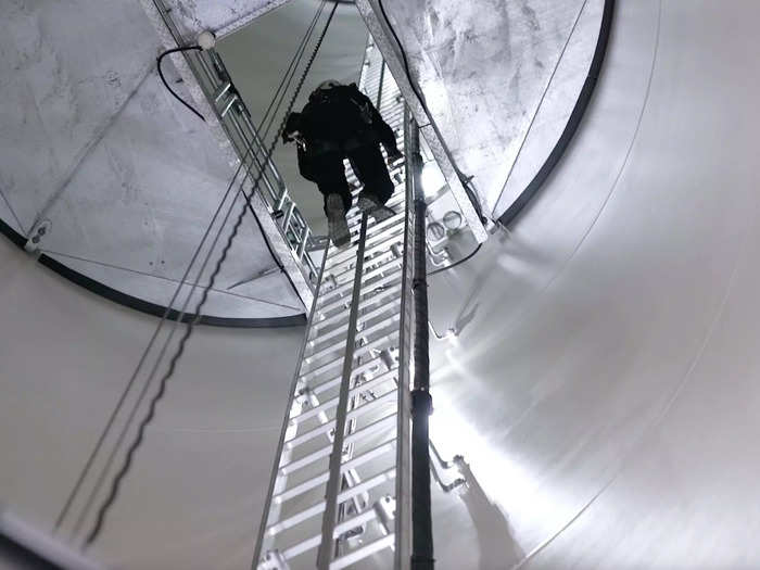 To inspect a finished turbine, Sardo climbs a ladder to the top.