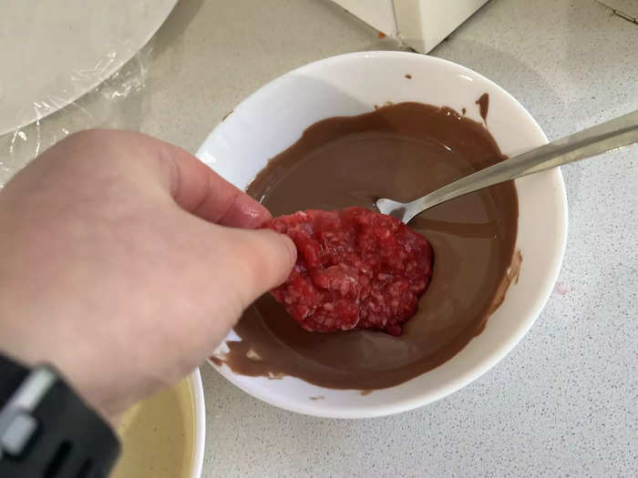 The video then said to dip the frozen raspberry disks into the chocolate. This was a little fiddly as the raspberries were melting quickly, which made it difficult to coat them in chocolate.