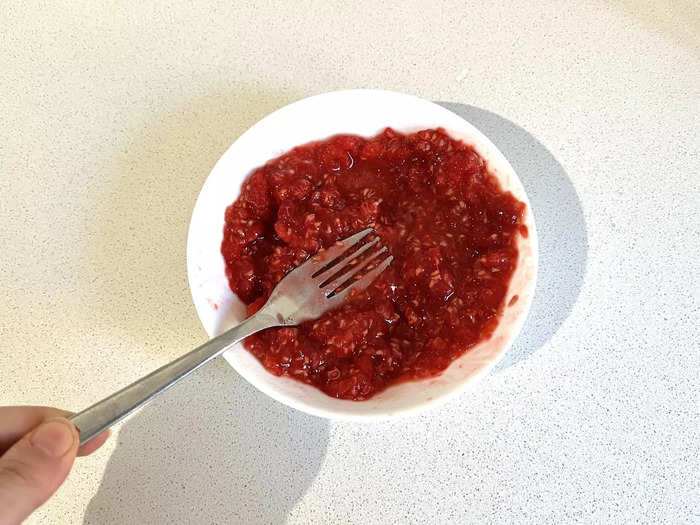 I began by washing the raspberries and then squishing them into a paste.