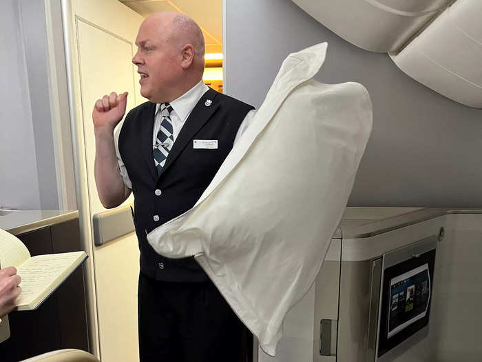 Then the script was flipped and I was put in the shoes of a flight attendant, starting with the turndown service. Baxter explained that the pillow should be held by the corners, and the duvet is folded at a 45-degree angle.