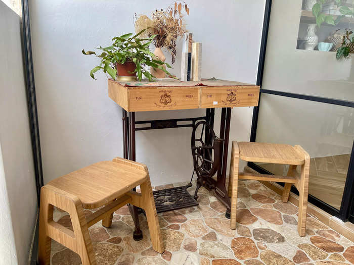 Other furniture items are DIY projects. The couple even turned a vintage sewing machine and used wine crates into a mini table for their balcony.