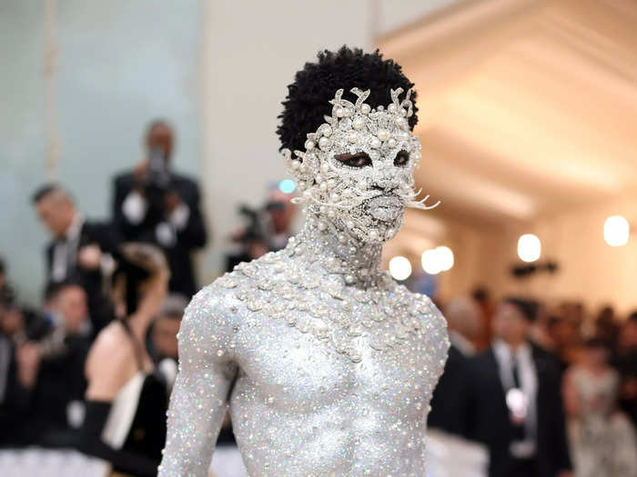 Lil Nas X teamed up with makeup artist Pat McGrath to create a sparkly silver cat look using crystals and pearls.