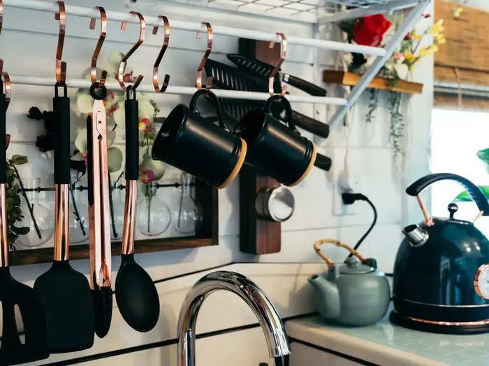 The kitchen is equipped with a fridge, microwave, coffee maker, and hot water kettle.