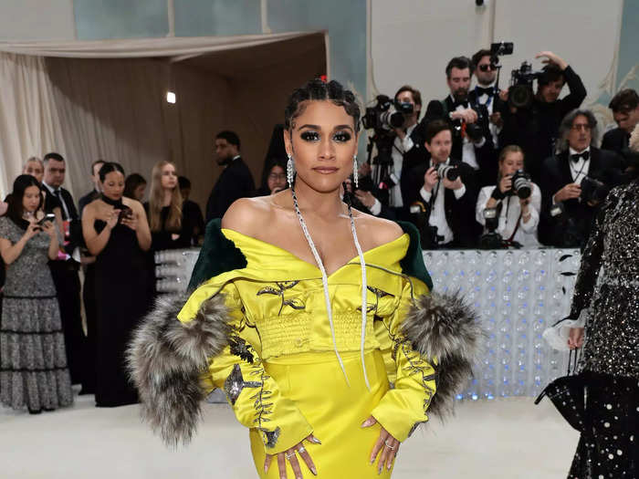 Ariana DeBose stood out on the Met Gala carpet with a canary-yellow ensemble.