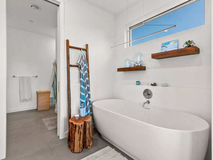 The tub is separated from the toilet and sink for privacy.